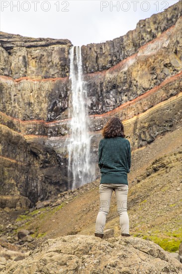 A young girl sitting in one of the wonders of Iceland