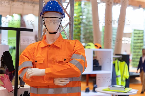 Construction workwear overalls on a mannequin at the expo. Mid shot