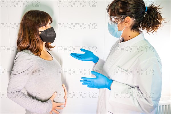 Female doctor and patient with face mask in a routine consultation. Antibodies