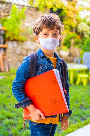 Caucasian child with face mask ready for back to school. New normality