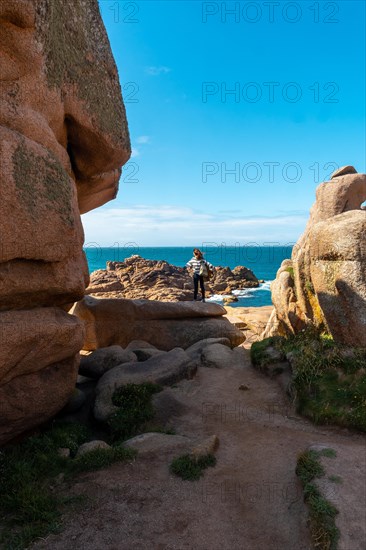 A young woman looking at the sea along Lighthouse Mean Ruz