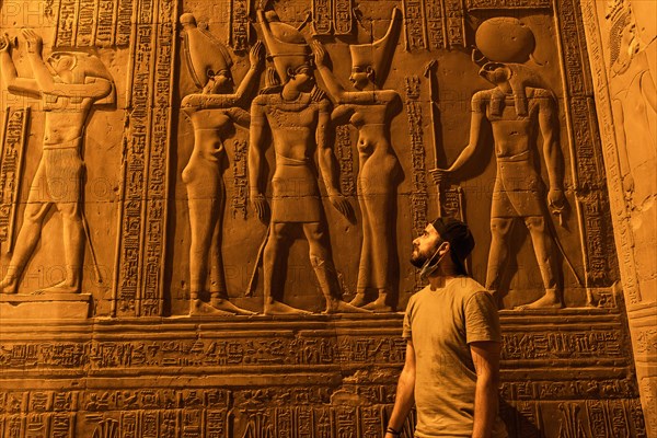A young man visiting the beautiful temple of Kom Ombo at night