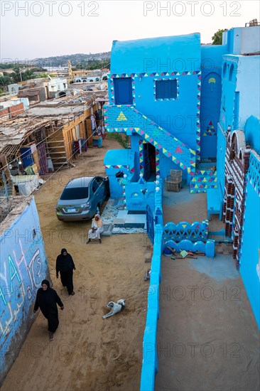 Stairs of colors that go up to a beautiful terrace of a traditional blue house in a Nubian village next to the Nile river and near the city of Aswan. Egypt