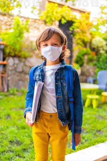 Caucasian child with face mask ready for back to school. New normality