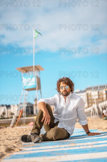 Summer lifestyle with a young dark-haired Caucasian man with long beard