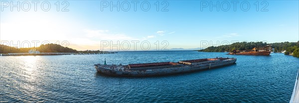 Panoramic of abandoned boat in the port of Roatan at dawn. Honduras