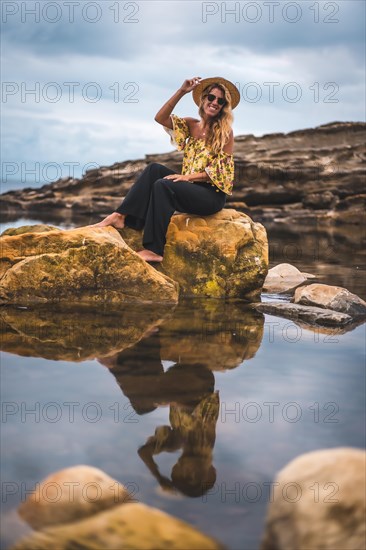Caucasian blonde girl in a floral shirt