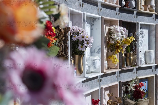 Wall with decorated urns graves in a cemetery in Sardinia