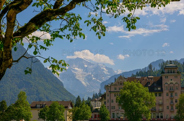 Hotel and Snow Capped Jungfraujoch Mountain in a Sunny Day in Interlaken