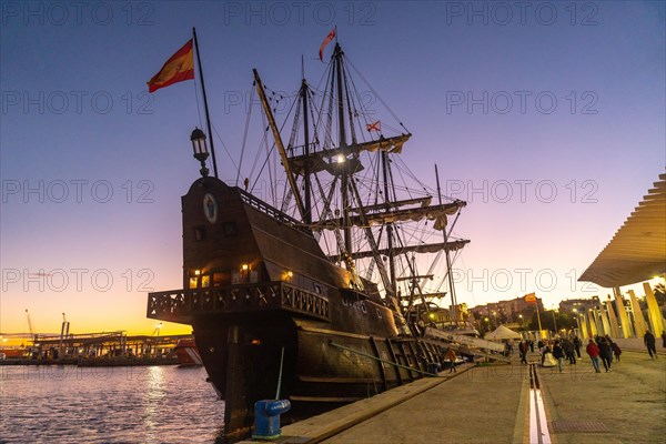 Old boat at sunset on the promenade of Muelle Uno in the Malagaport of the city of Malaga