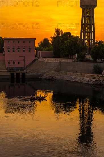 A town near the river at sunset on the Nile river cruise. Egypt. Sailing from Luxor to Aswan