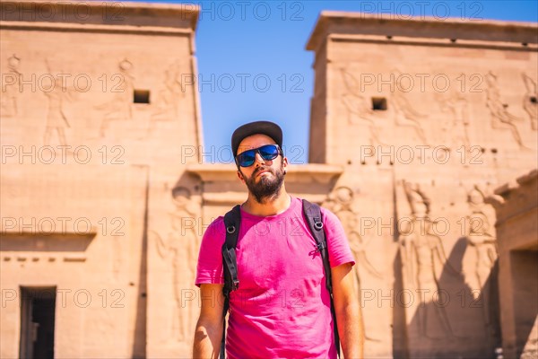 A young man in a pink shirt at the Temple of Philae