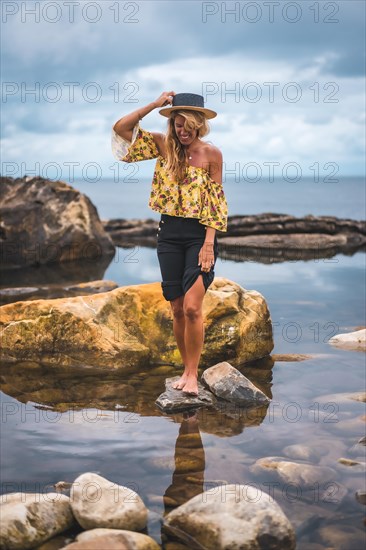 Caucasian blonde girl in a floral shirt