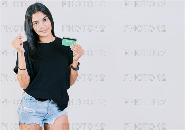 Girl holding credit card making money gesture with fingers isolated