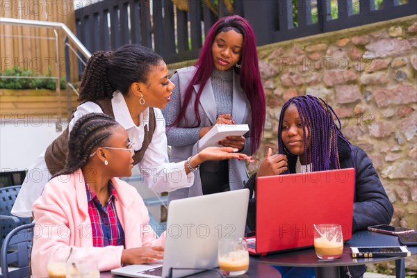 Young and alternative businesswomen of black ethnicity. In a team-building meeting