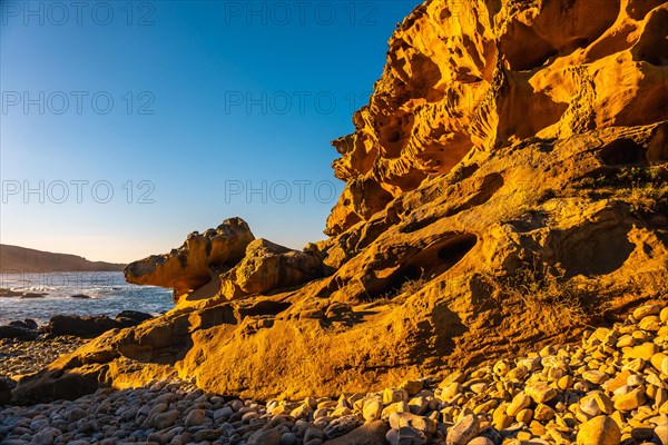 Sunset in the cove of stones in the mountain of Jaizkibel in the town of Pasajes near San Sebastian. Basque Country