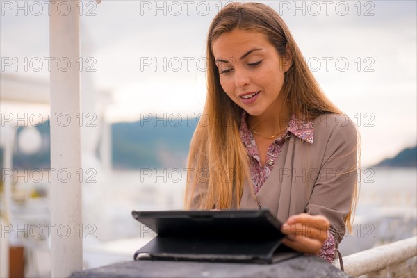 An executive woman and businesswoman in the break from work reviewing the agenda on a tablet