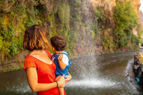 A mother with her son on vacation at Anjos Waterfall