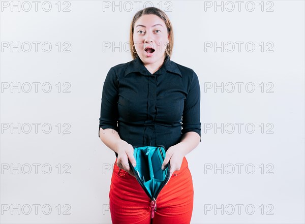Shocked young woman showing empty wallet isolated. Unemployed girl without money showing empty wallet