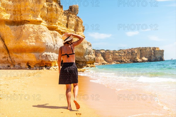 A woman enjoying the summer on the beach at Praia da Coelha