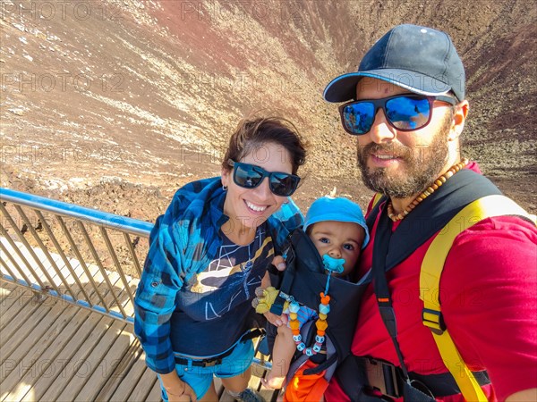 A family on the crater of the Calderon Hondo volcano near Corralejo