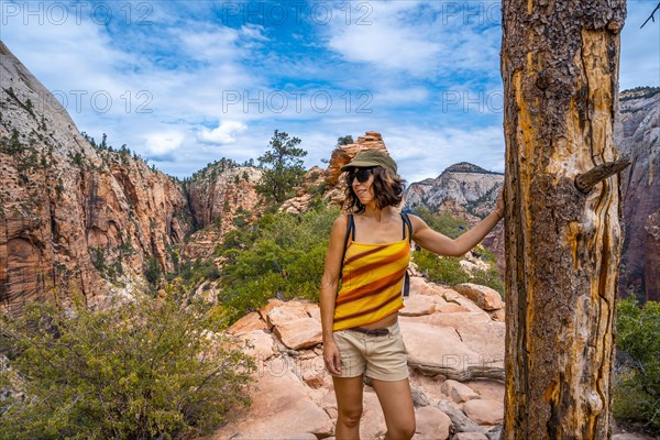 A young woman on top of the trekking of the Angels Landing Trail in Zion National Park
