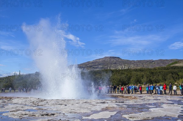 Geysir Strokkur with the sun in the background of the golden circle of the south of Iceland