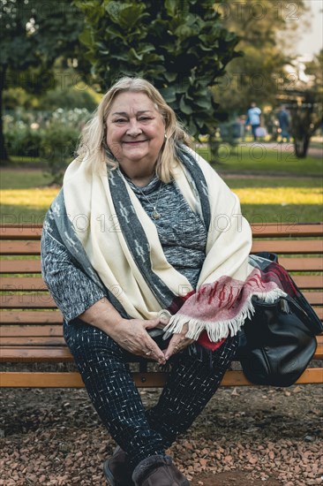 Portrait of a cheerful senior woman relaxing outdoors