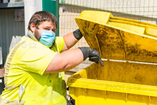 Worker in a recycling factory or clean point and garbage with a face mask and with security protections