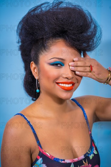 A closeup portrait of a fashion attractive rocker style woman with bright makeup wearing a leather jacket