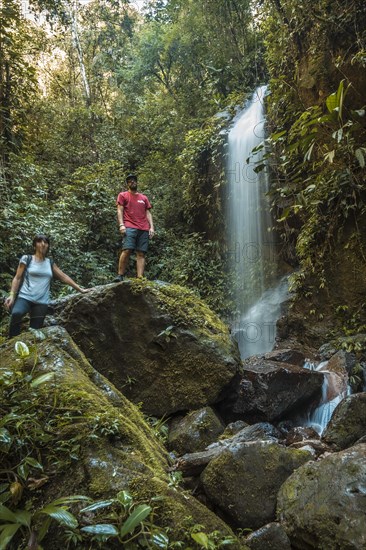 A copule with his arms raised in the Waterfall of the Cerro Azul Meambar