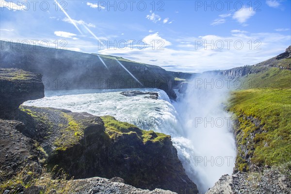 The Gullfoss waterfall in the golden circle of the south of Iceland with lots of water one summer morning