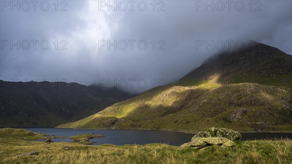 Lake Llyn Llydaw with Mount Snowdon behind clouds in late summer