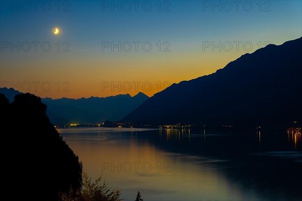 View over Lake Brienz with Mountain and Moon in Twilight in Bernese Oberland