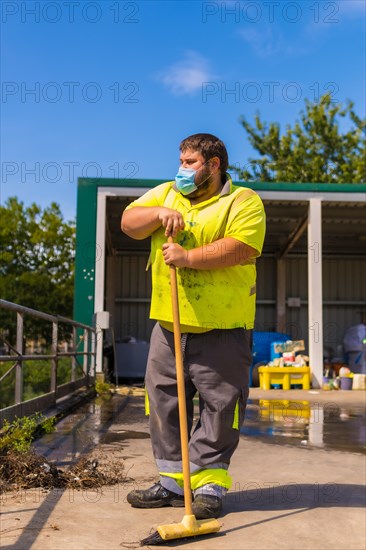 Worker in a recycling factory or clean point and garbage with a face mask and with security protections