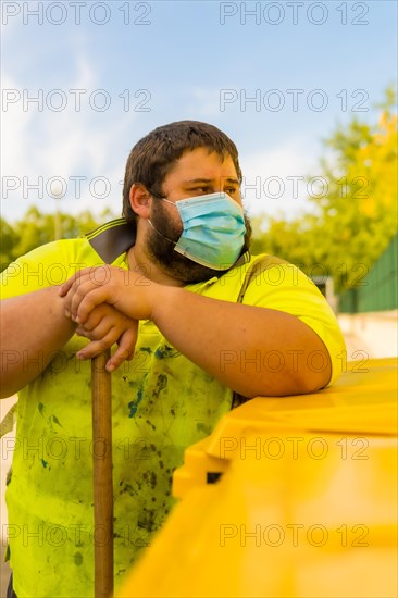 Worker in a recycling factory or clean point and garbage with a face mask and with security protections