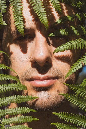 A young boy inside ferns in nature. Listorreta Natural Park in the town of Errenteria in the Penas de Aya or Aiako Harria park. Gipuzkoa