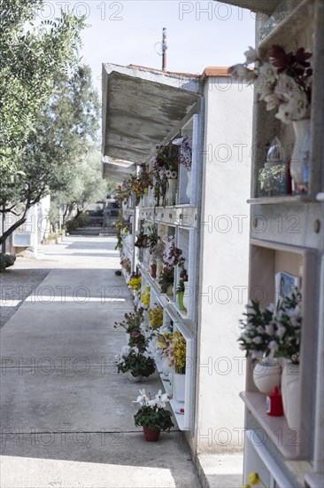 Wall with decorated urns graves in a cemetery in Sardinia