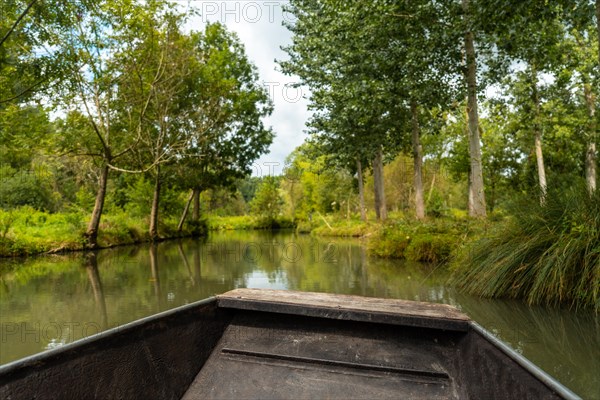 Sailing by boat on the natural water channels between La Garette and Coulon