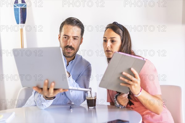 A couple teleworking at home