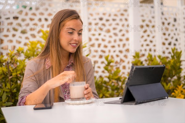 Executive woman and businesswoman having breakfast in a restaurant having a decaffeinated coffee