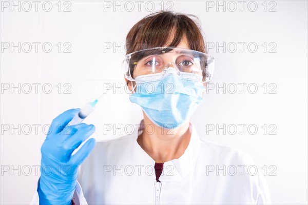 Female doctor with transparent glasses face mask with coronavirus vaccine