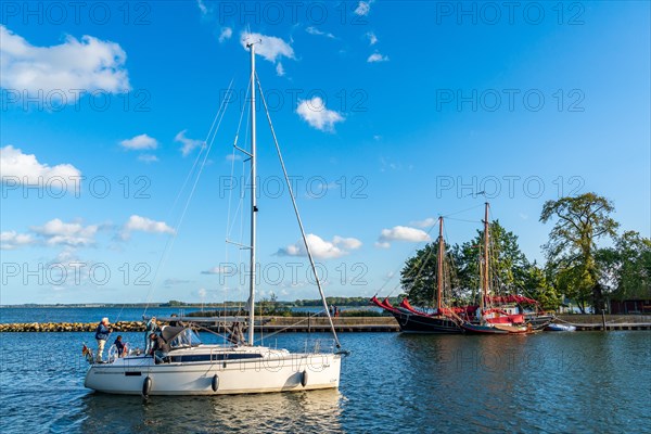 Sailing yacht sails from the Greifswalder Bodden into the river Ryck