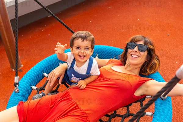 Baby playing in a playground having fun in summer