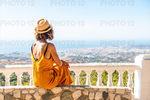 A young woman looking from the viewpoint in the municipality of Mijas in Malaga. Andalusia