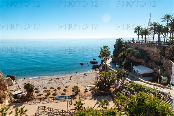 Calahonda beach in the town of Nerja with people sunbathing in spring