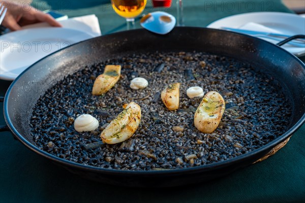 Black rice with cuttlefish and young garlic