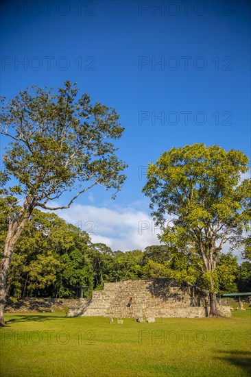 A young girl climbing a pyramid in The Copan Ruins temples. Honduras