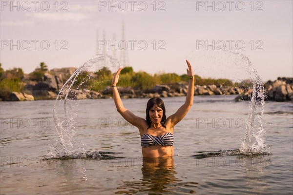 A young tourist bathing in the water of a Nubian village on the river Nile and near the city of Aswan. Egypt