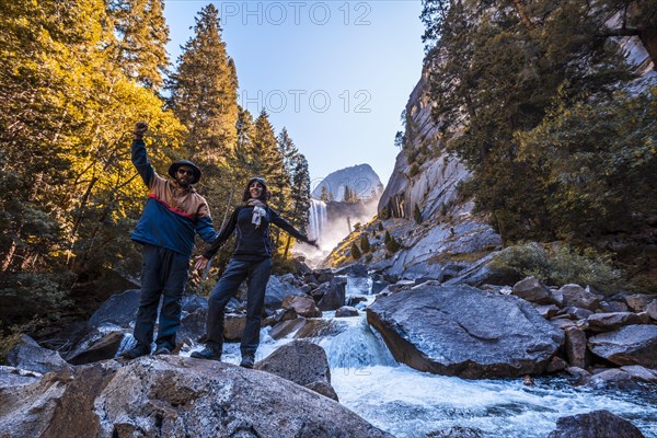 A couple in Vernal Falls waterfall of Yosemite National Park